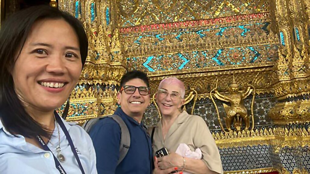 Private Bangkok tour with guide Kanny – Jenson G. visiting the Grand Palace and posing in front of intricate golden temple carvings