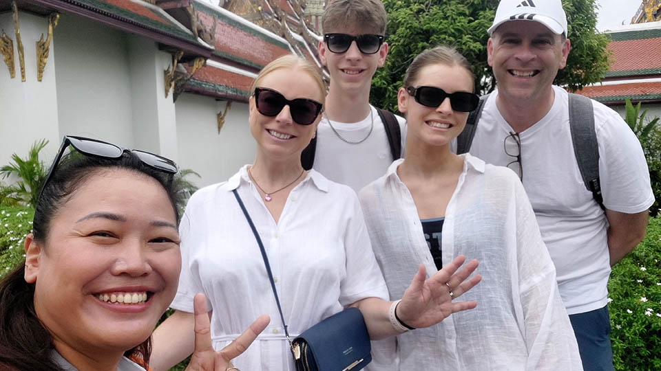 Joanna S. and family with Bangkok tour guide Apple visiting a temple complex in Thailand