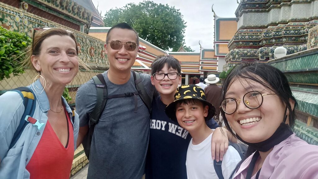 Keri S. and family with Bangkok tour guide Ticha visiting Wat Pho temple in Thailand