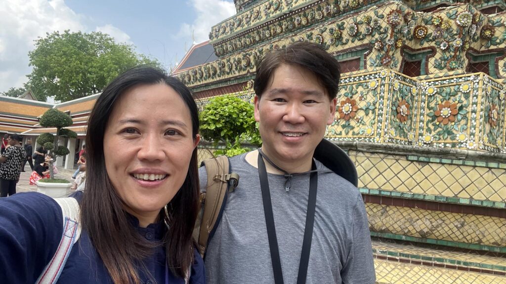 Private Bangkok tour with guide Kanny – Kevin F. visiting Wat Pho temple and posing in front of colorful floral tilework