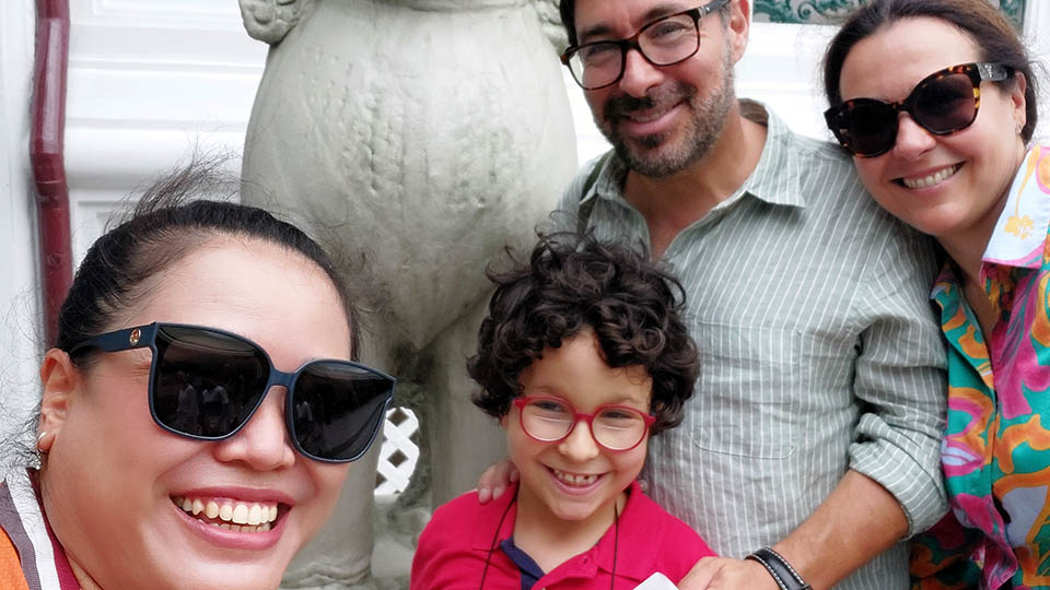 Marianela R. and family with Bangkok tour guide Apple posing at the Grand Palace in Thailand